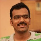 A man practicing contract driven development wearing glasses and a green shirt.